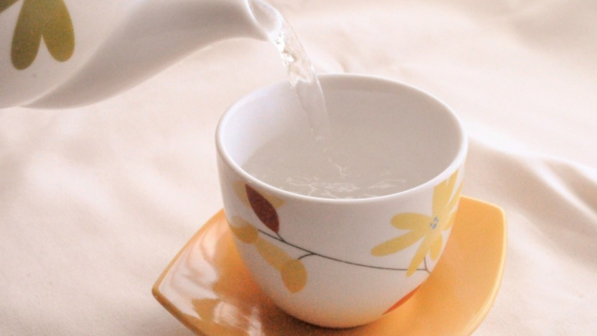 Hot water poured from a teapot into a cup, the simplest way to cool it
