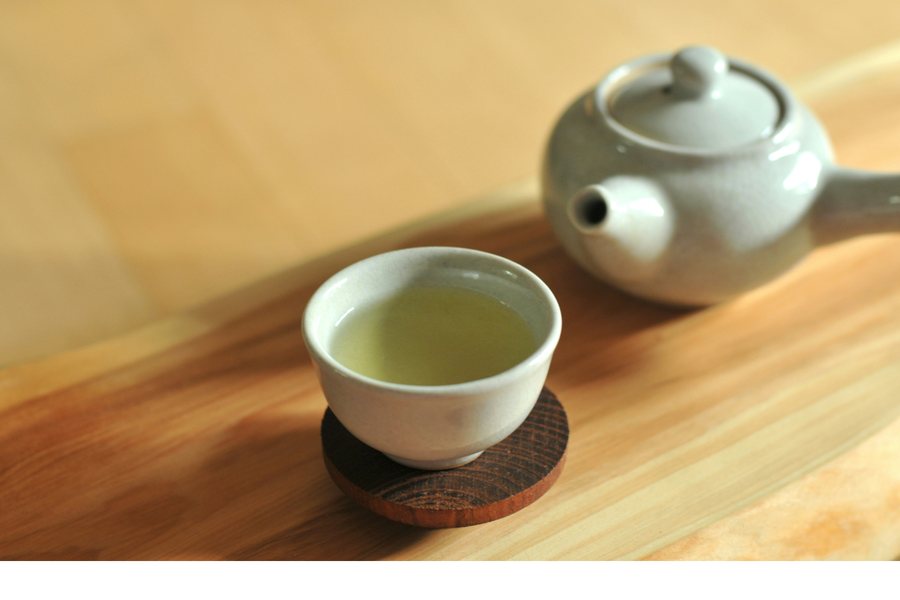 A simple iron teapot and cups in a quiet tea room