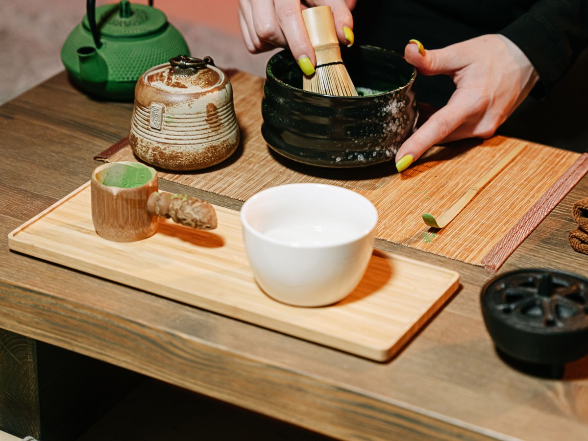 Matcha being whisked into a froth in a bowl